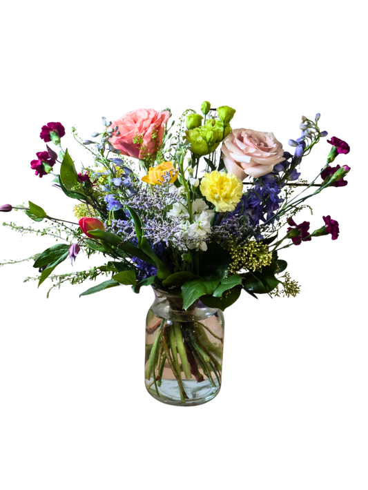 Designer's Choice vase arrangement with vibrant uplifting seasonal flowers arranged in a clear glass vase
